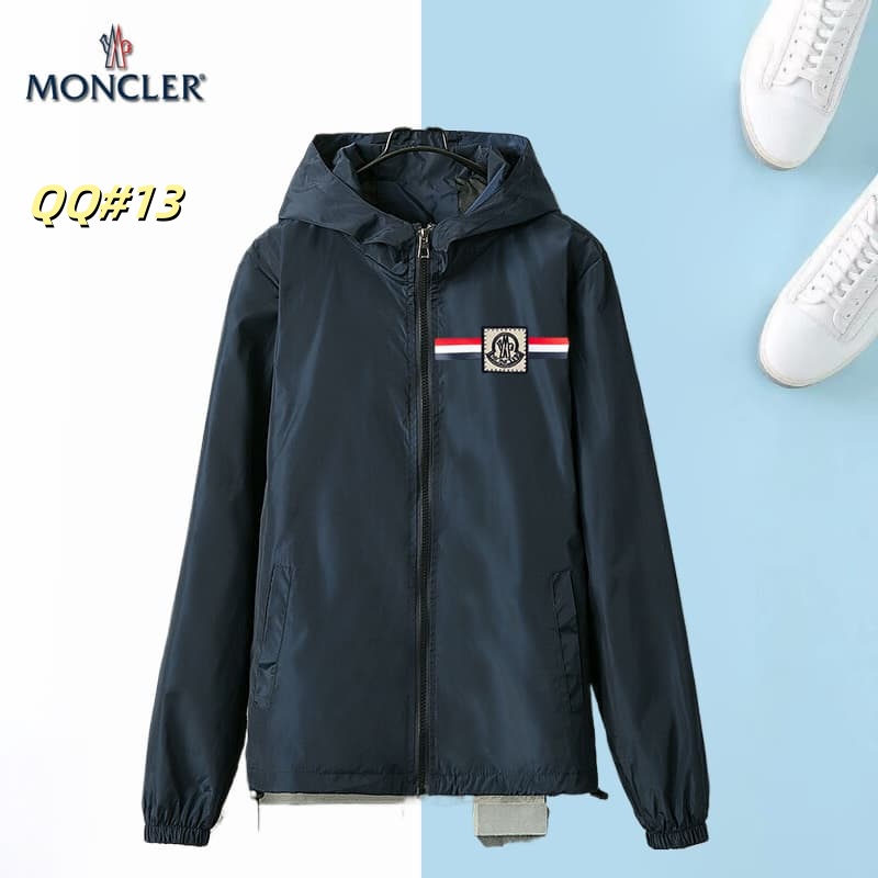 Front view of a black hooded windbreaker jacket with a horizontal red, white, and blue stripe across the left chest and a circular logo.