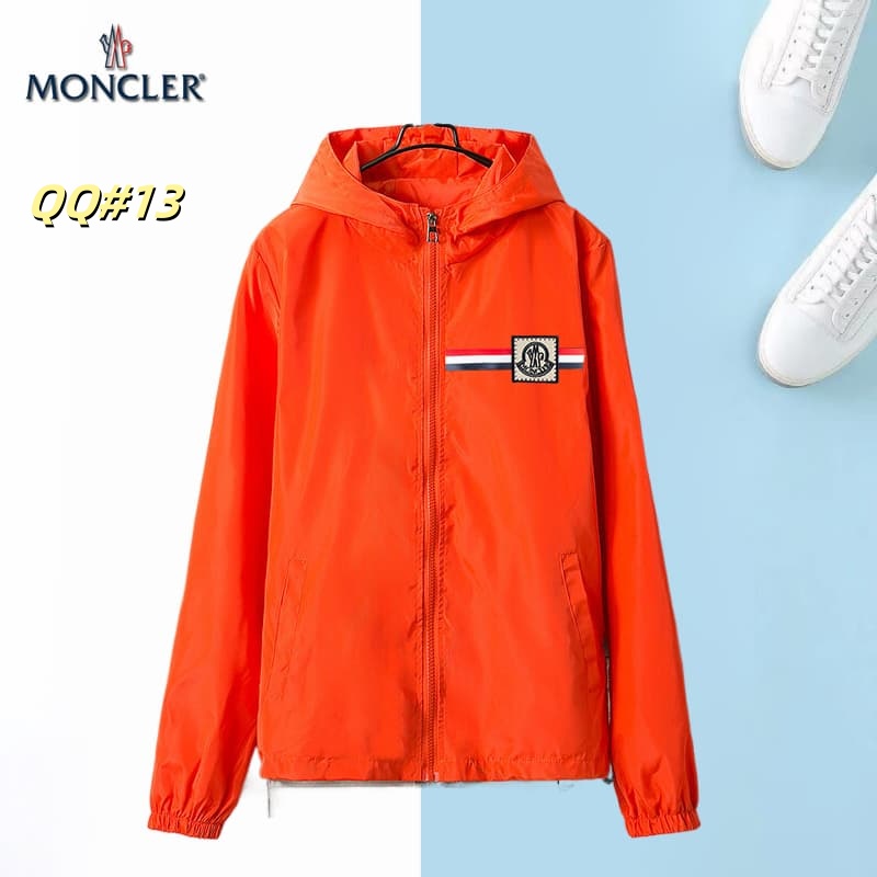 Front view of a black hooded windbreaker jacket with a horizontal red, white, and blue stripe across the left chest and a circular logo.