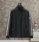 A black high-neck track jacket with white and grey racing stripes on the sleeves and a designer-style logo on the left arm.