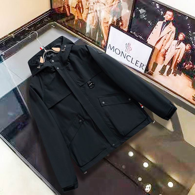 Flat lay view of a heavy-duty black tactical field parka with large cargo pockets and a snap-front closure.