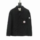 Matte black shirt-jacket with a button-front closure, pointed collar, and signature circular logo patches on the chest and arm.