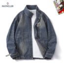 Moncler-style blue denim jacket with diagonal white stripes, a stand collar, and gold-tone snap-button closures over a central zipper. Features a circular logo patch on the chest.