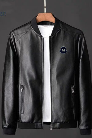 faux leather bomber jacket with a full zip front, black ribbed collar and cuffs, and a black circular patch with a white 'M' logo on the left chest.