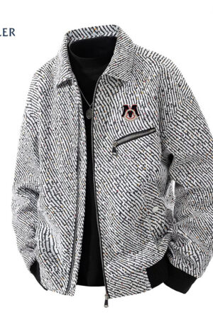 A textured grey corduroy bomber jacket with a speckled pattern, featuring a signature "M" logo and a silver zipper on the chest.