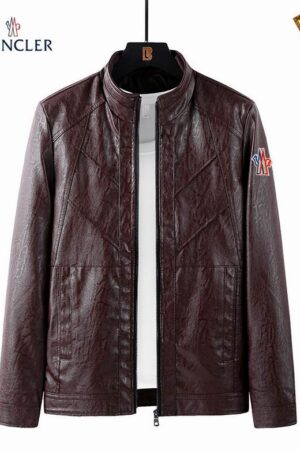 A dark burgundy or brown faux leather jacket with a stand-up collar and subtle quilted diagonal lines forming chevron patterns across the shoulders and chest. A red, white, and blue logo patch is visible on the left arm.