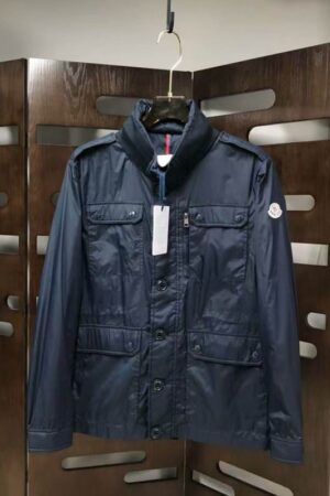 navy blue military field jackets with four front flap pockets and a high collar.