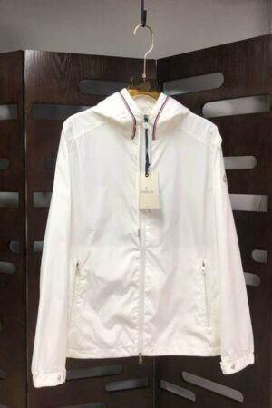 Crisp white lightweight windbreaker jacket with tricolor trim on the hood and a small logo on the sleeve.