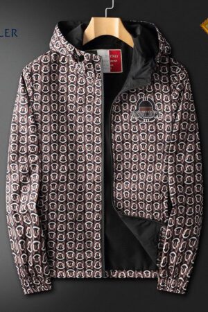 Moncler-style men's full-zip hooded jacket with a repeating circular logo pattern in brown, black, and white. The jacket has a small branded patch on the chest and a black inner lining.