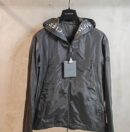 Dark grey technical hooded jacket with white branding visible inside the hood and long vertical zippered side pockets.