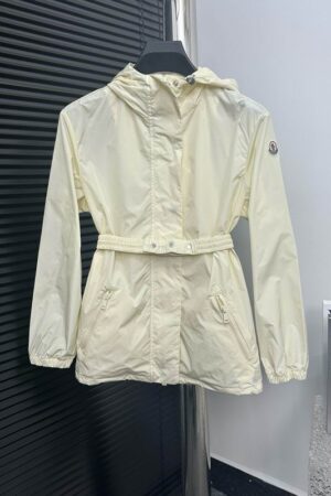 Luxury-inspired Moncler Tyx windbreaker jacket in cream with a signature logo patch on the sleeve and a functional hood.